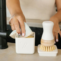 close up of Nellies dish butter and forever brush next to kitchen sink