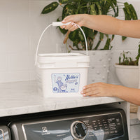 Placing 500 load bucket of laundry detergent on laundry room counter