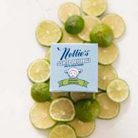 Nellie's Bergamot Scented Dryerball box on top of a bed sliced limes