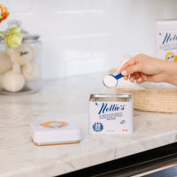 Scooping 50 load laundry detergent in tin