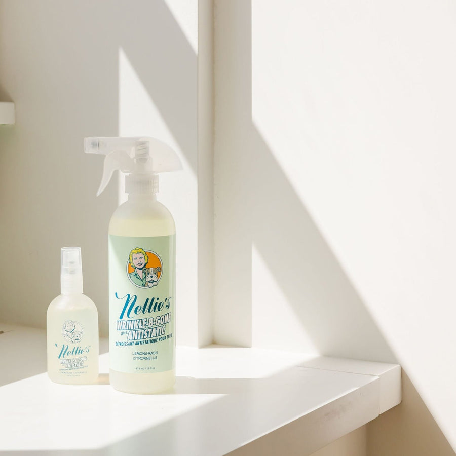 Large plastic bottle and small glass bottle of Nellie's Wrinkle-B-Gone in window