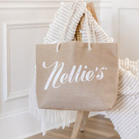 Brown Jute Tote bag with rope handles hanging on chair