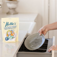 Putting dirty dish into dishwasher