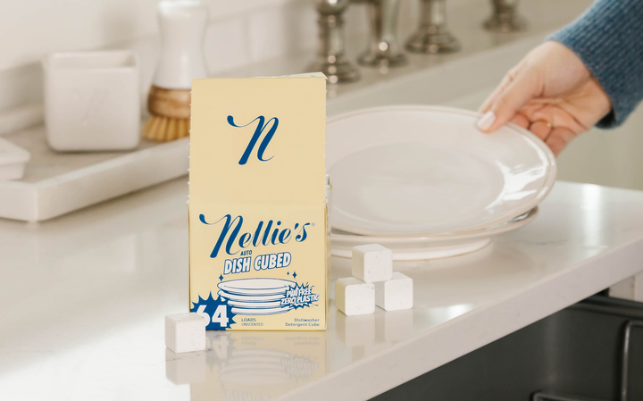 Nellie's Dish Cubes on counter and dishes being loaded into the dishwasher.