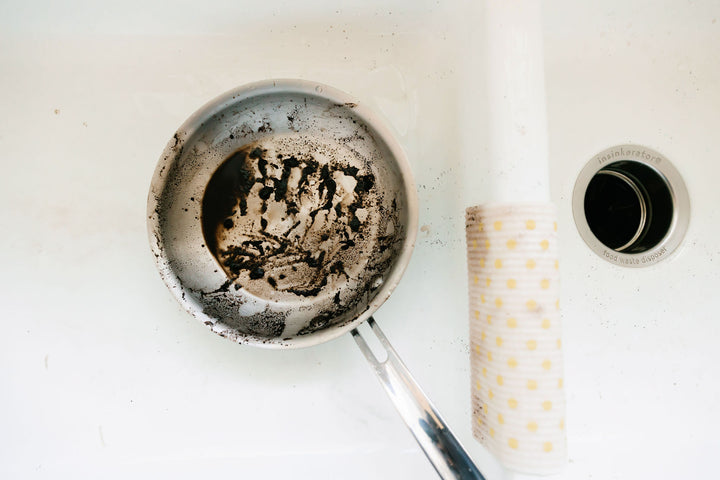 Pan with burnt food stuck on it. 