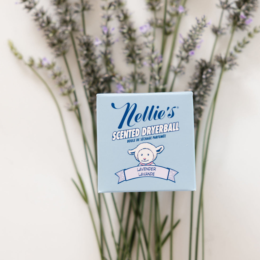 Nellie's Lavender Scented Dryerball packaging on a bed of lavender