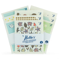 A pack of Nellie's Swedish Dishcloths featuring a fall-themed floral pattern on the front, with additional patterned dishcloths fanned out behind it on a white background.