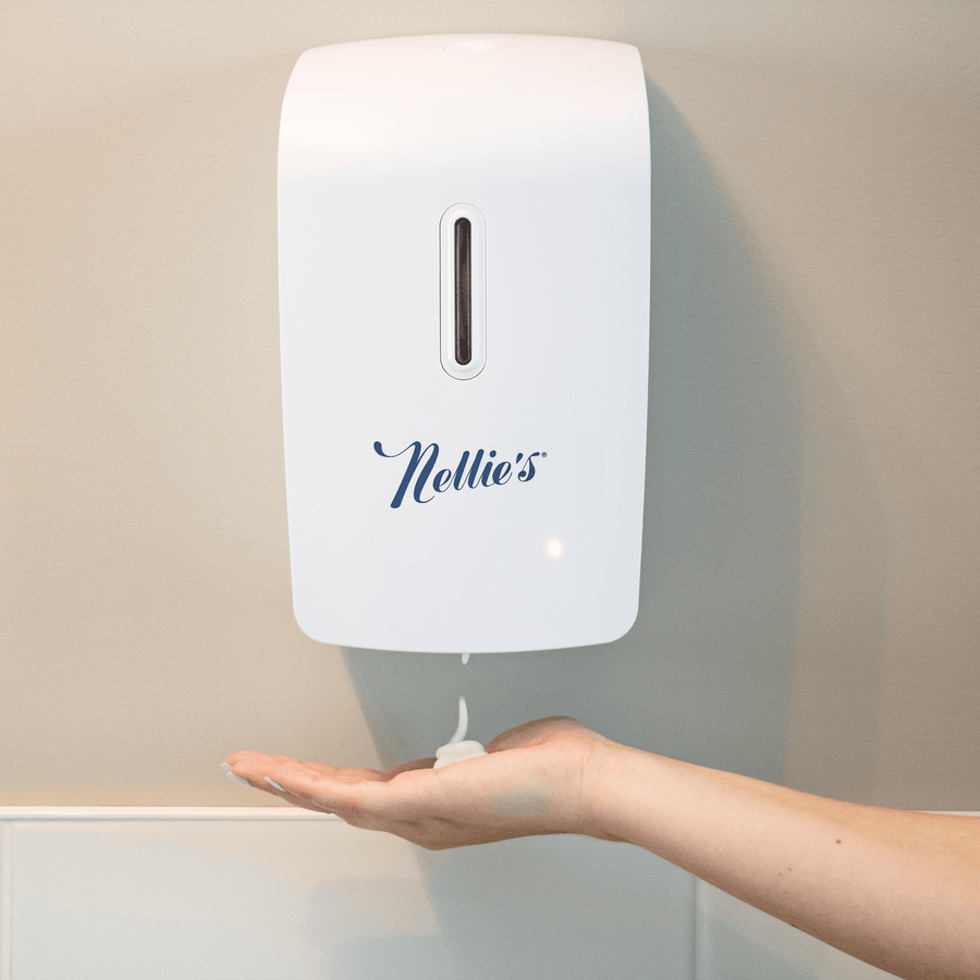 Foam soap coming out of a wall mounted soap dispenser