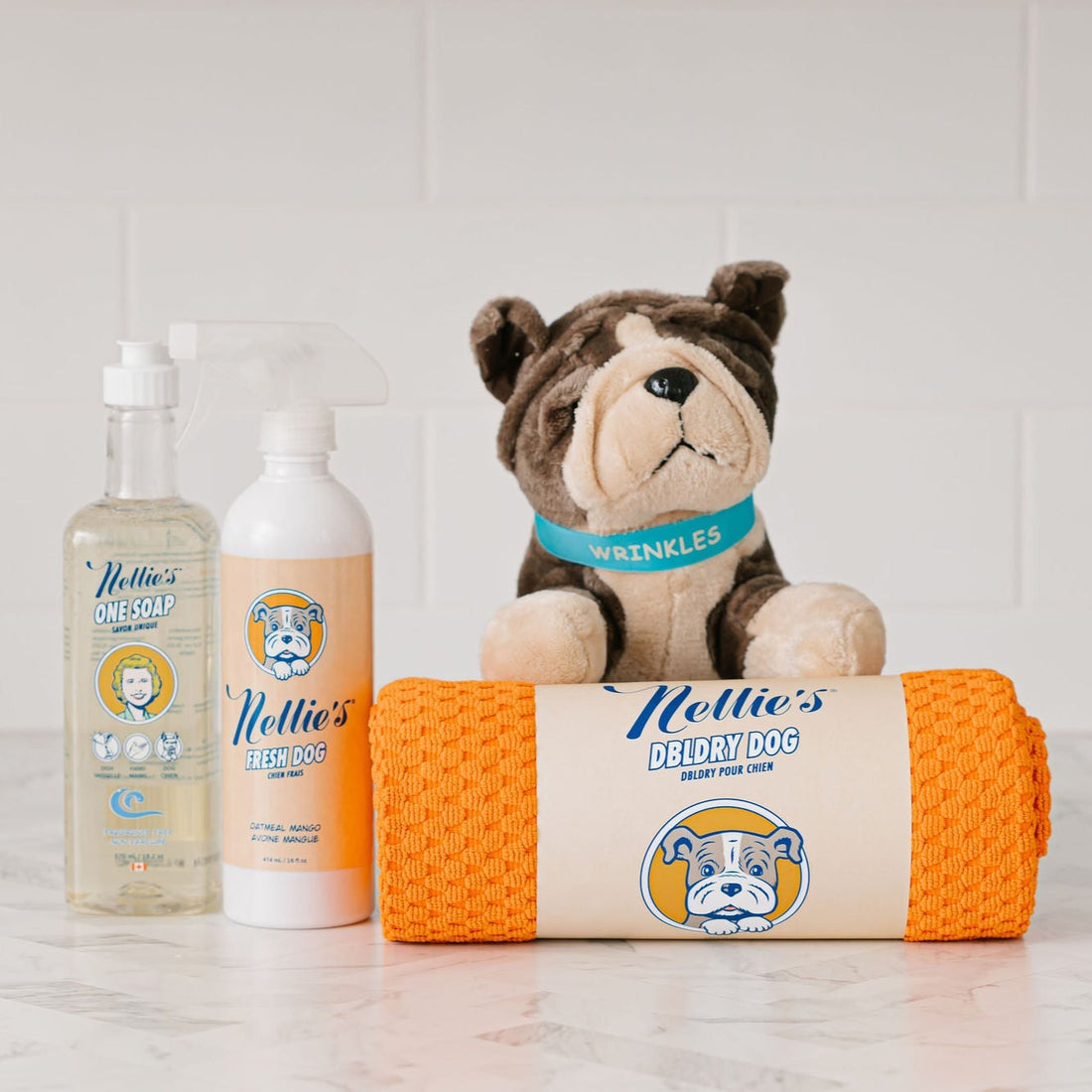 Pet Bundle laid on counter with pet towel, wrinkles stuffed toy, Fresh Dog spray, and fragrance free  One saop for washing pets. 