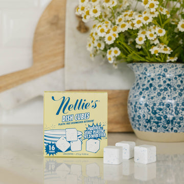 Nellie's Dish Cubes packaging on a kitchen counter with flowers in the background