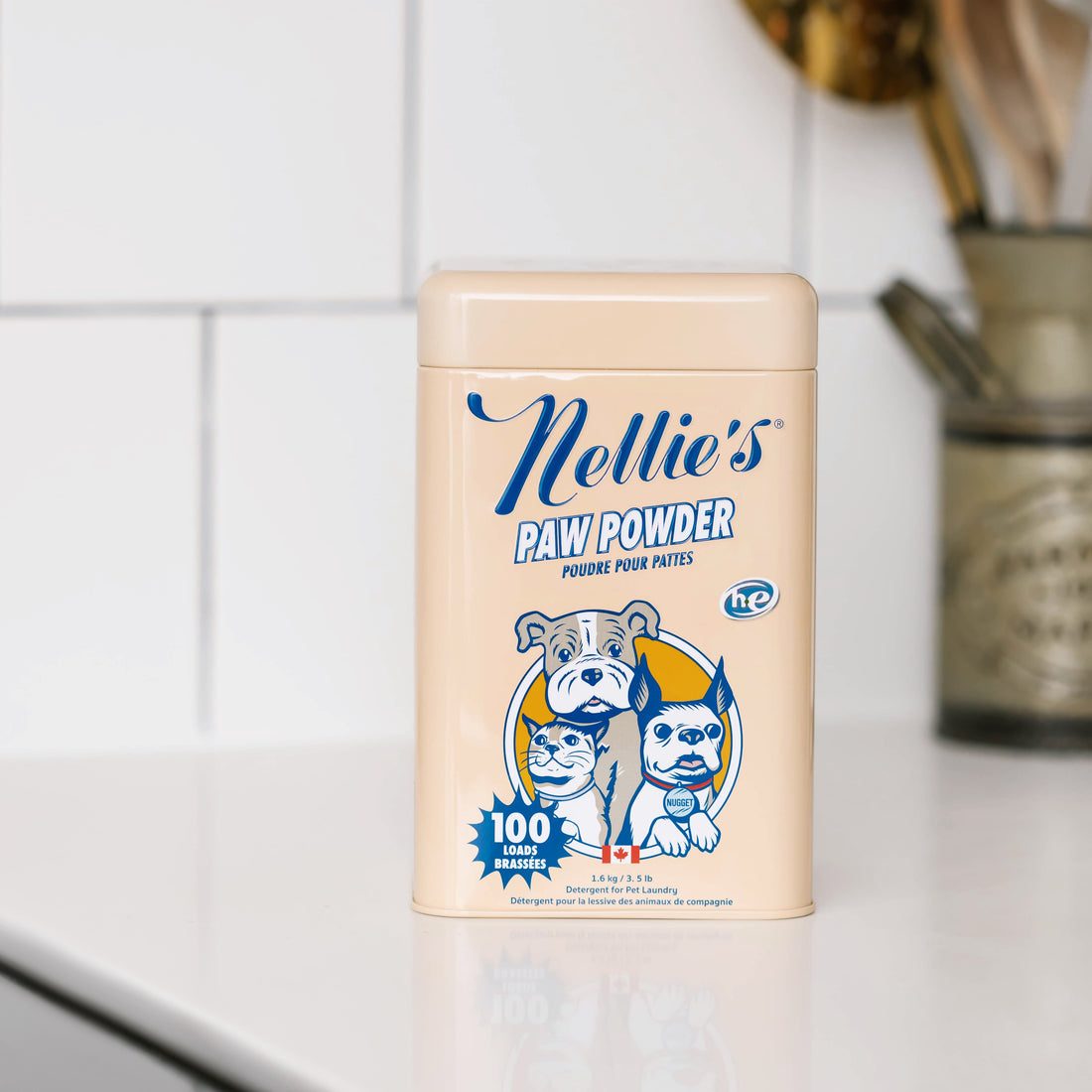 Nellie's Paw Powder container on a kitchen counter with a tiled wall background