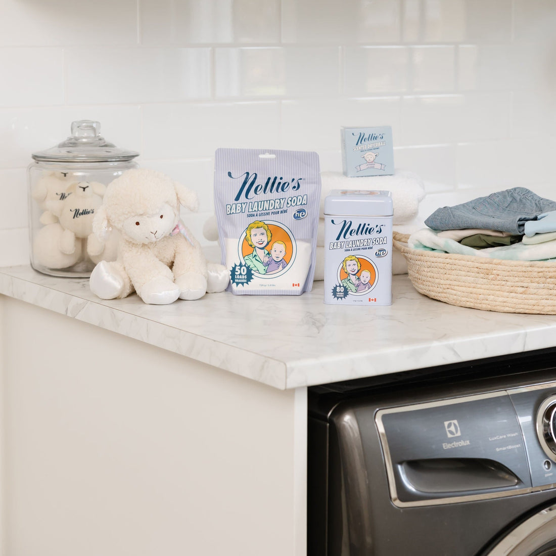 White stuffed lamb with baby laundry in laundry room