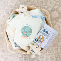Basket with baby clothes and Baby Laundry detergent