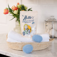 Laundry pods in basket with Nellie's blue Dryerballs
