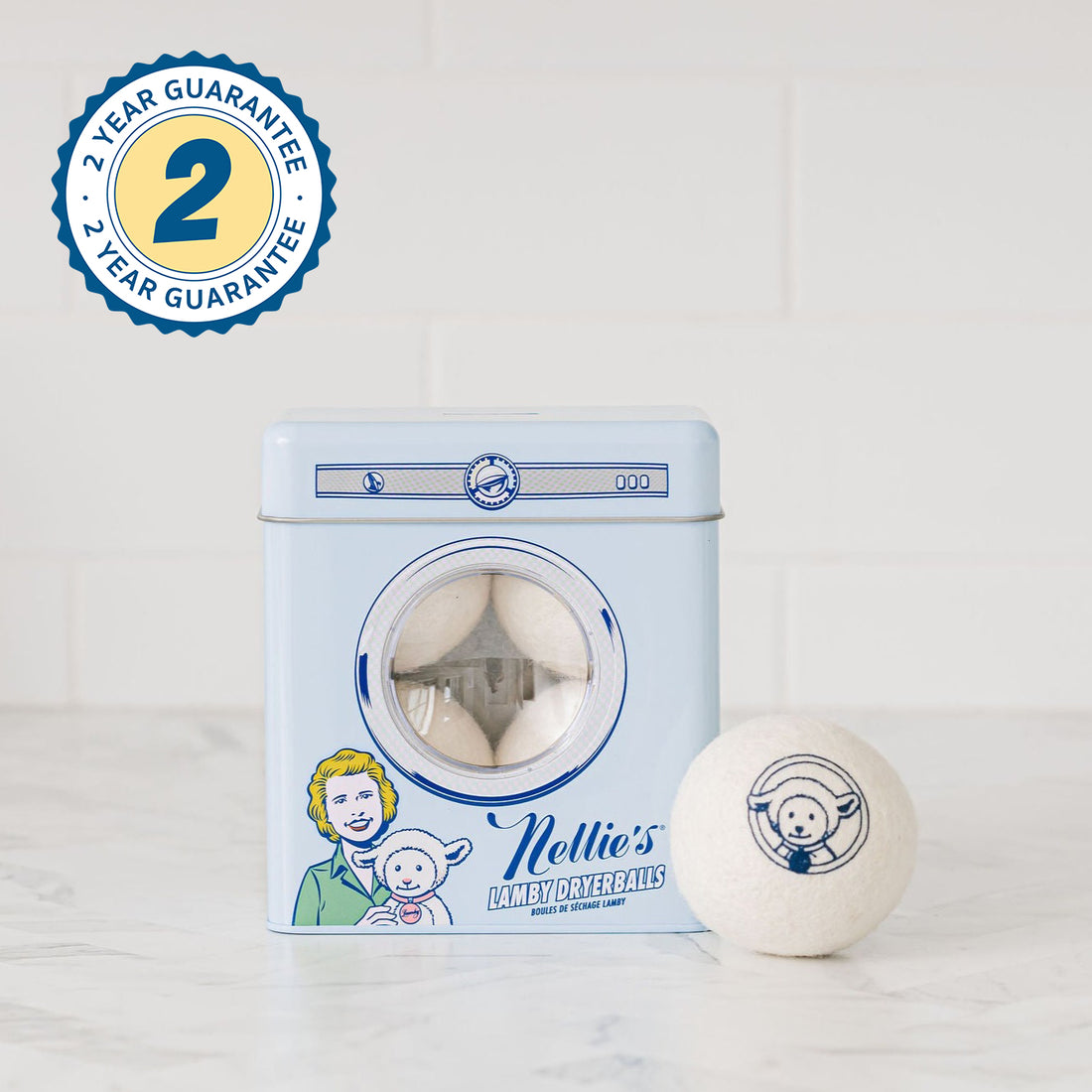 Set of 4 wool dryerballs in reusable tin, with a 2-year Guarantee sticker in the top left corner of image