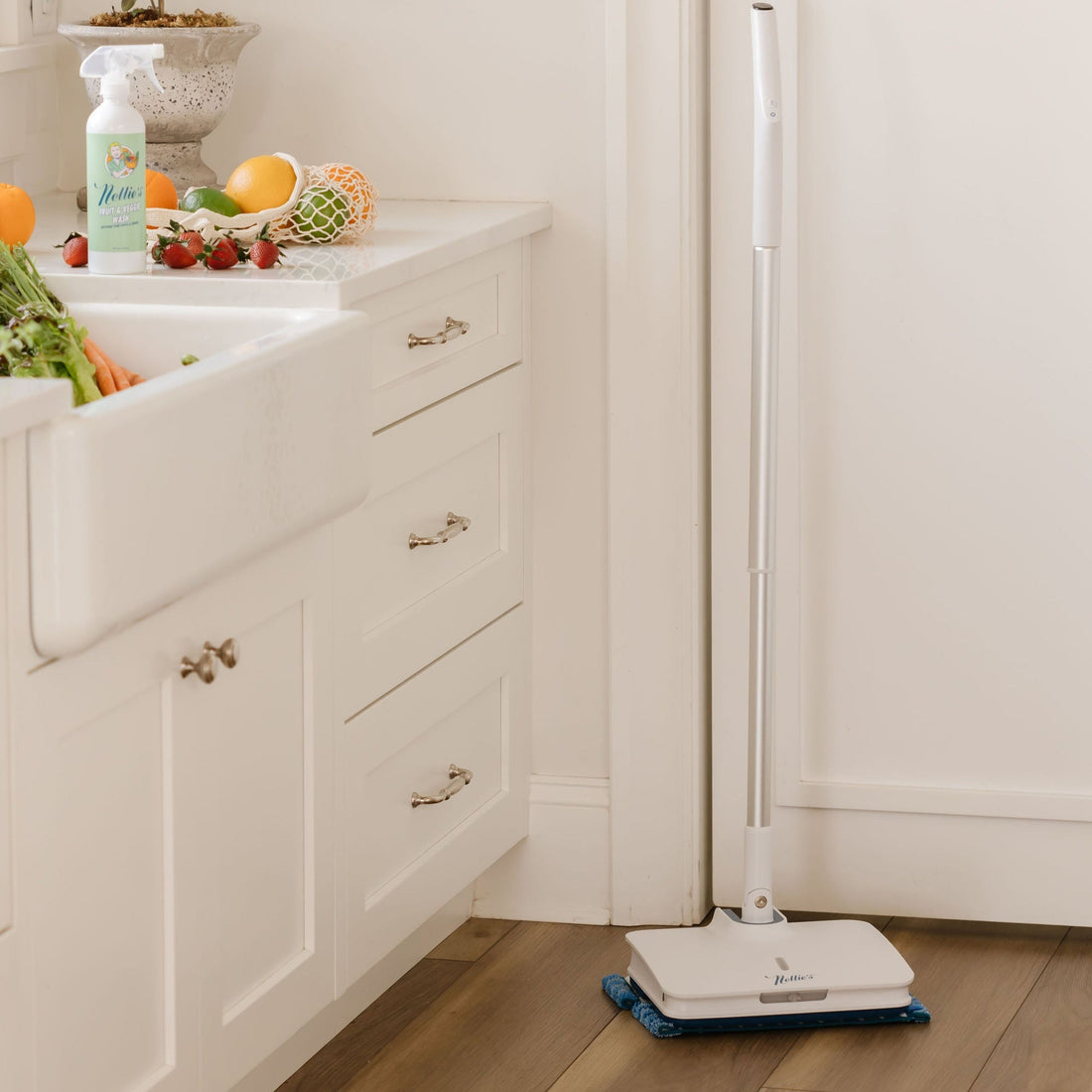 Fruit and vegetable wash and fruit on counter with electric mop on floor 